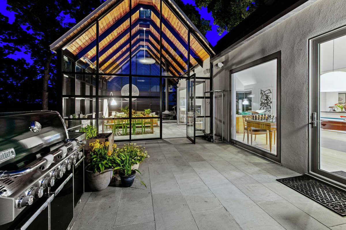 The glass-enclosed great room at the home on 10 Dragonwood Lane in Weston, Conn. was inspired by the Louvre in Paris.