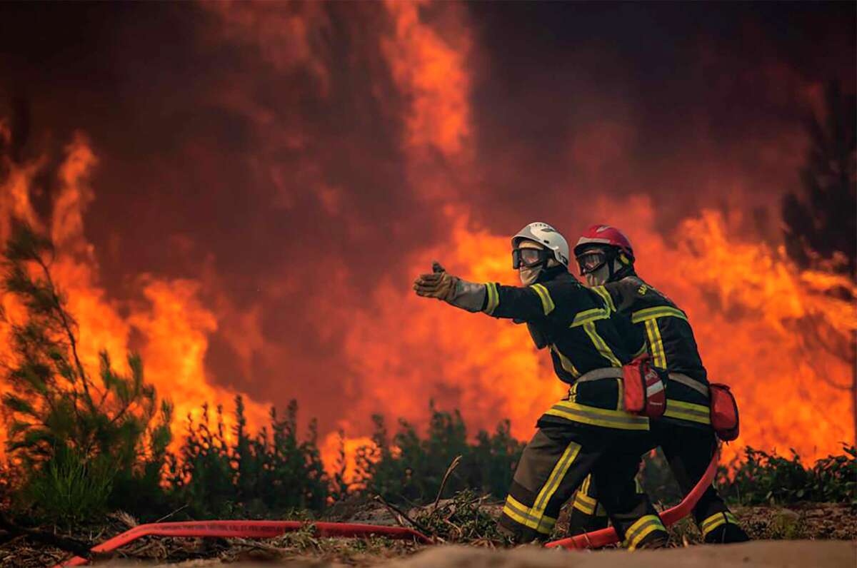 France scrambled more water-bombing planes and hundreds more firefighters to combat spreading wildfires that were being fed Monday by hot swirling winds from a searing heat wave broiling much of Europe. (SDIS 33 via AP)