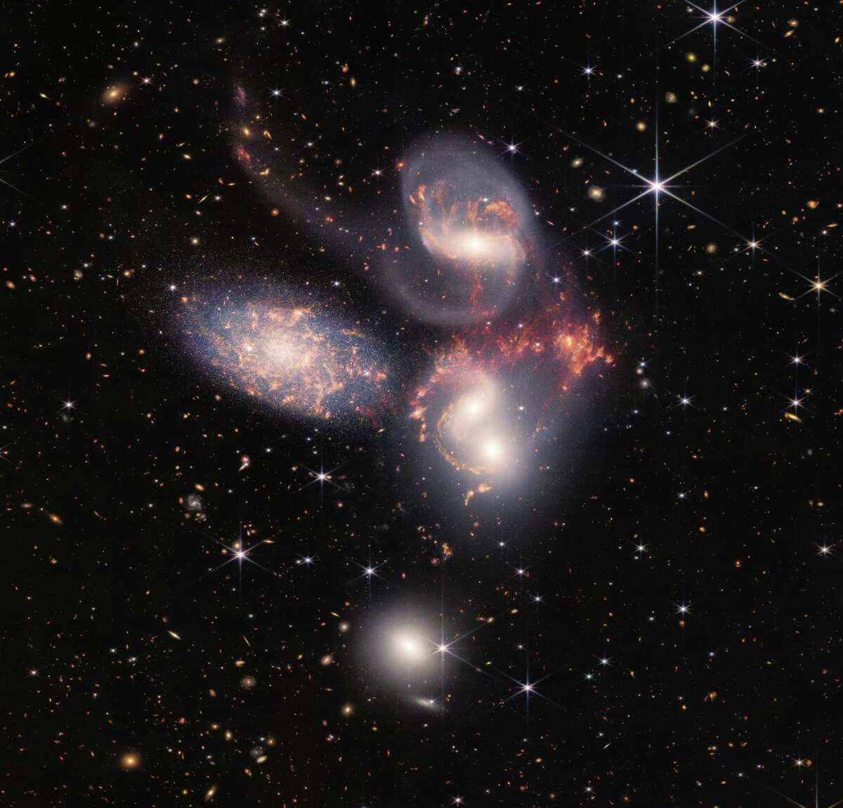 The James Webb Space Telescope captured this image of Stephan’s Quintet — a group of five galaxies, four of which appear as if they’re dancing with one another amid old stars.