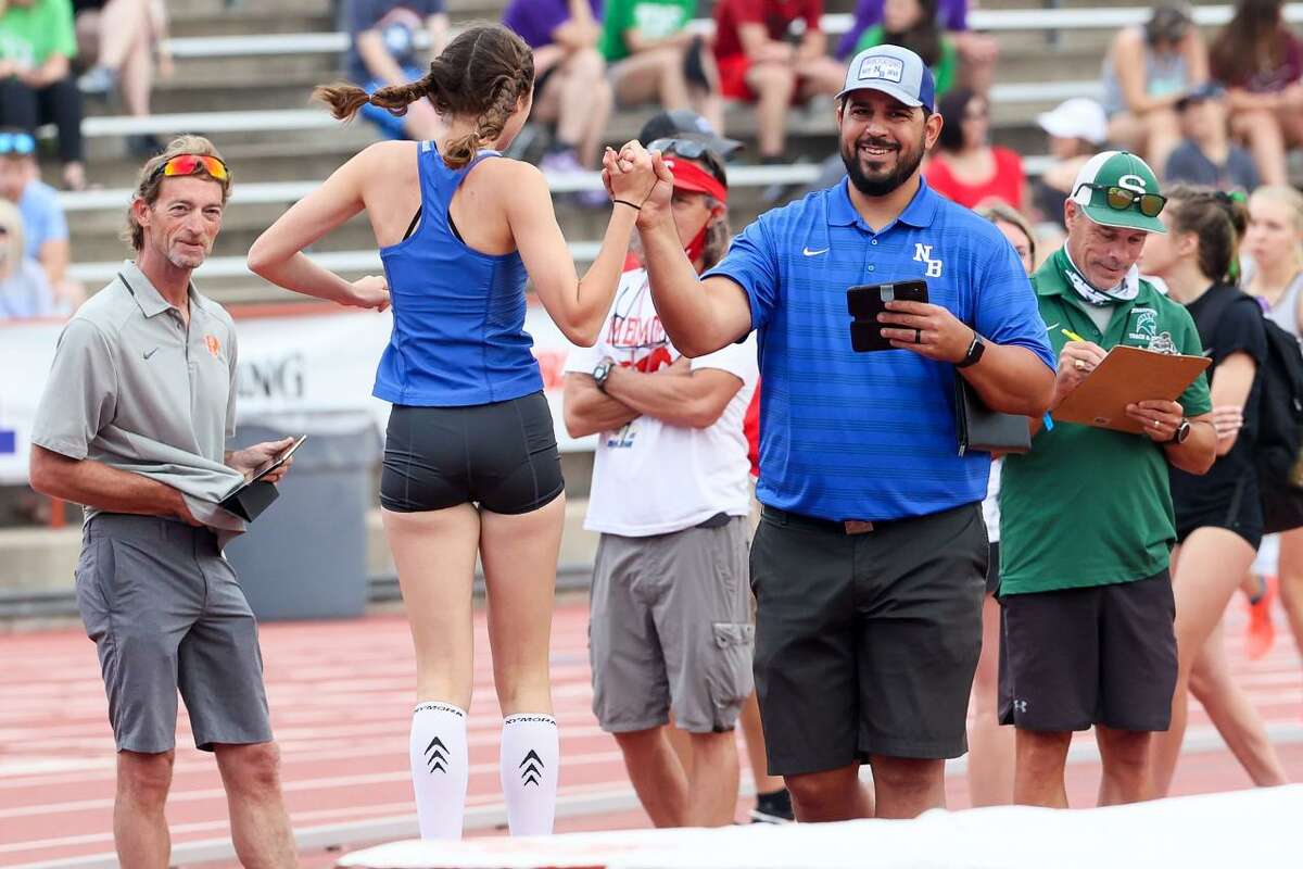 New Braunfels' Abigail Morrow leaps to greet coach Jimmy Keresztury after jumping 5-8 to take second place in the 6A girls high jump in the UIL state track and field championships at Mike A. Myers Stadium in Austin on Saturday, May 8, 2021.