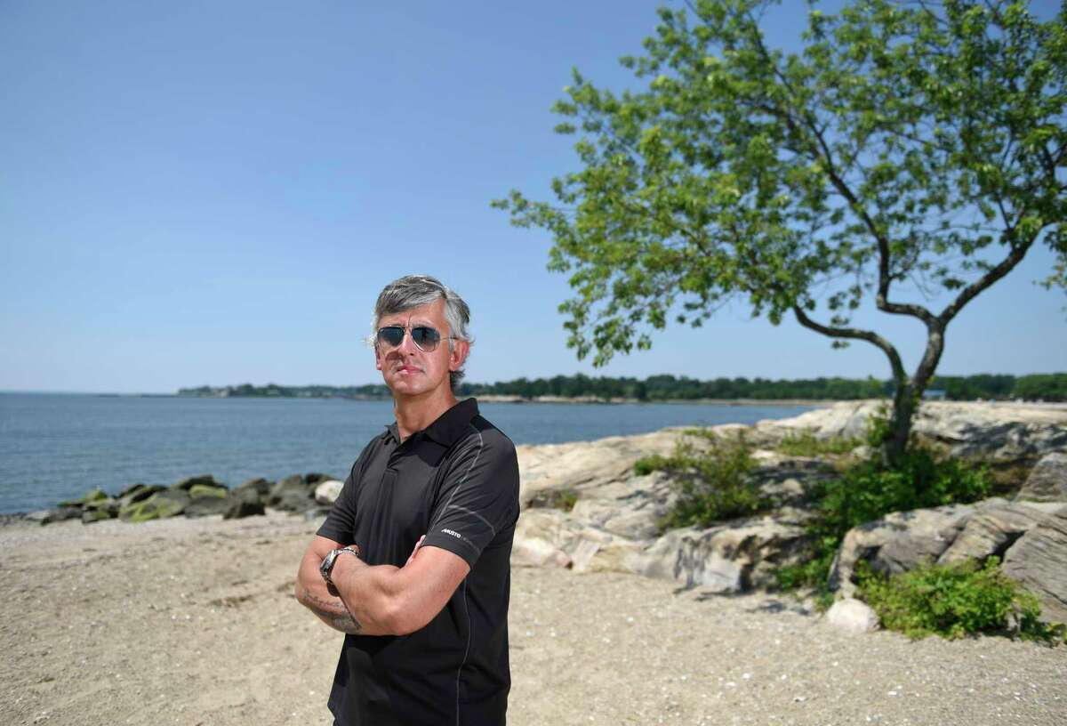 Darien resident David Roofthooft poses at Weed Beach in Darien, Conn. Tuesday, July 19 2022. Roofthooft made a documentary about a fatal 2018 shark attack in Cape Cod that will premiere during Shark Week this Saturday.