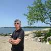 Darien resident David Roofthooft poses at Weed Beach in Darien, Conn. Tuesday, July 19 2022. Roofthooft made a documentary about a fatal 2018 shark attack in Cape Cod that will premiere during Shark Week this Saturday.