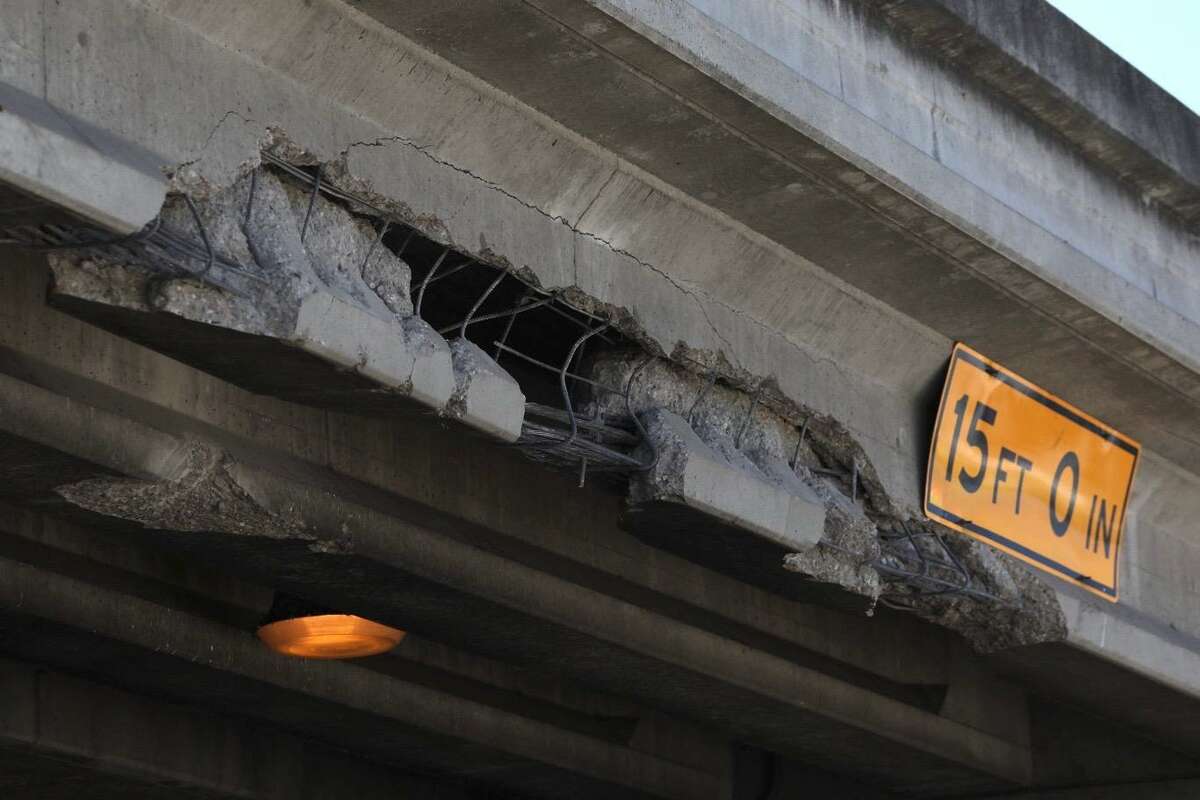 A chunk of concrete is missing from the I-80 overpass above Gilman Street in Berkeley, Calif. Wednesday, July 20, 2022. A semi-truck’s cargo collided with the overpass, causing significant damage. The driver fled the scene and police are still searching for them.