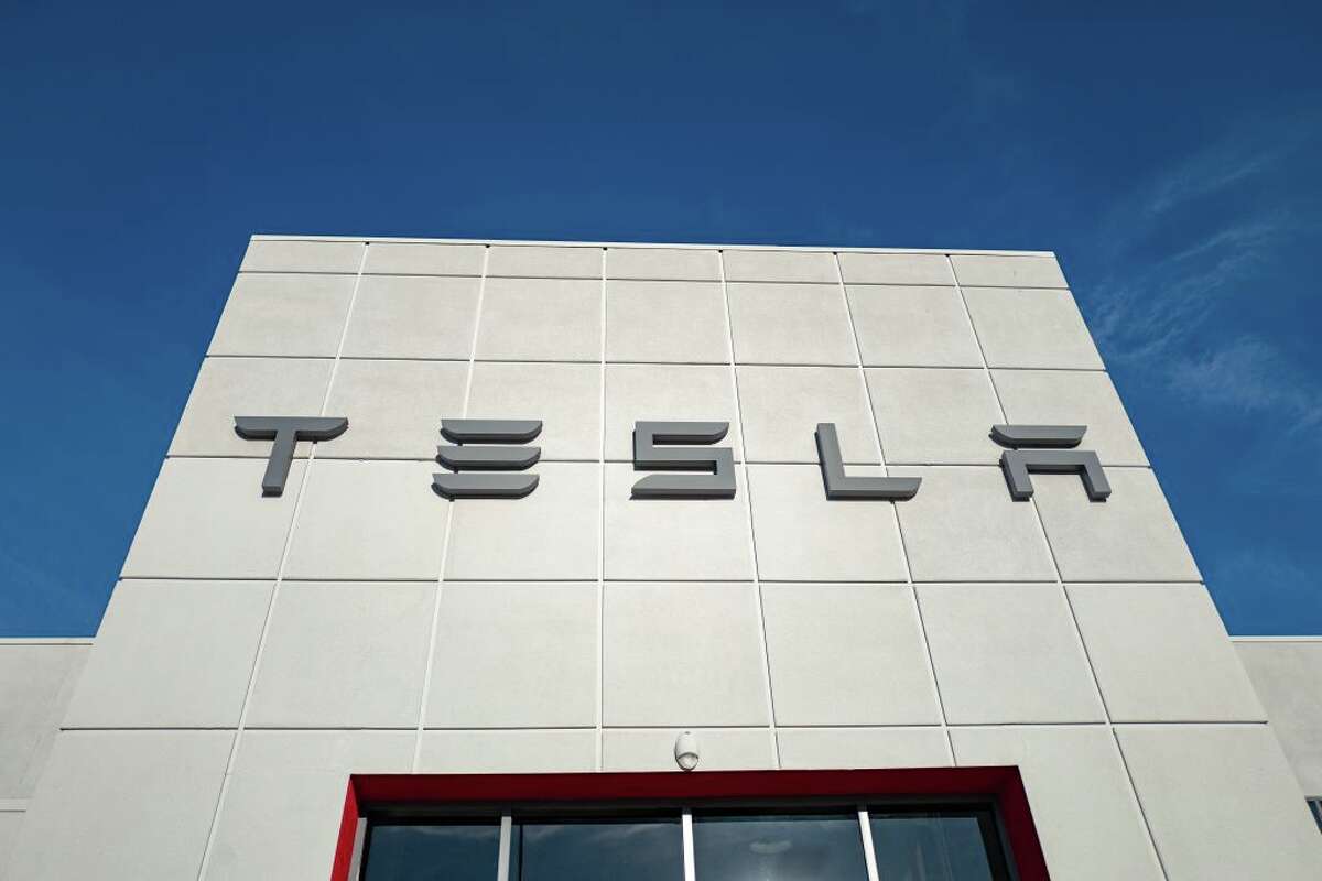 Low-angle view of the facade of Tesla Motors dealership with logo and sign in Pleasanton, California, July 23, 2018. (Photo by Smith Collection/Gado/Getty Images)