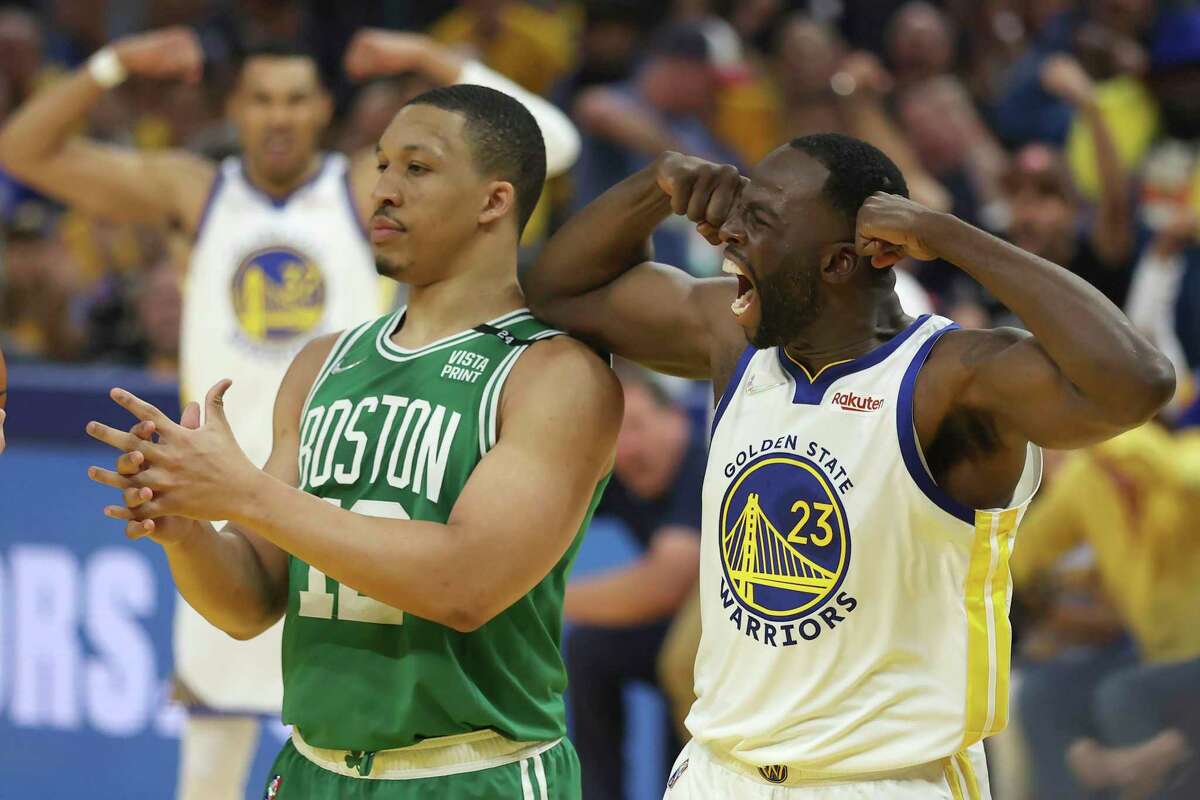 Golden State Warriors forward Draymond Green (23) reacts next to Boston Celtics forward Grant Williams during Game 1 of basketball's NBA Finals in San Francisco, Thursday, June 2, 2022. (AP Photo/Jed Jacobsohn)