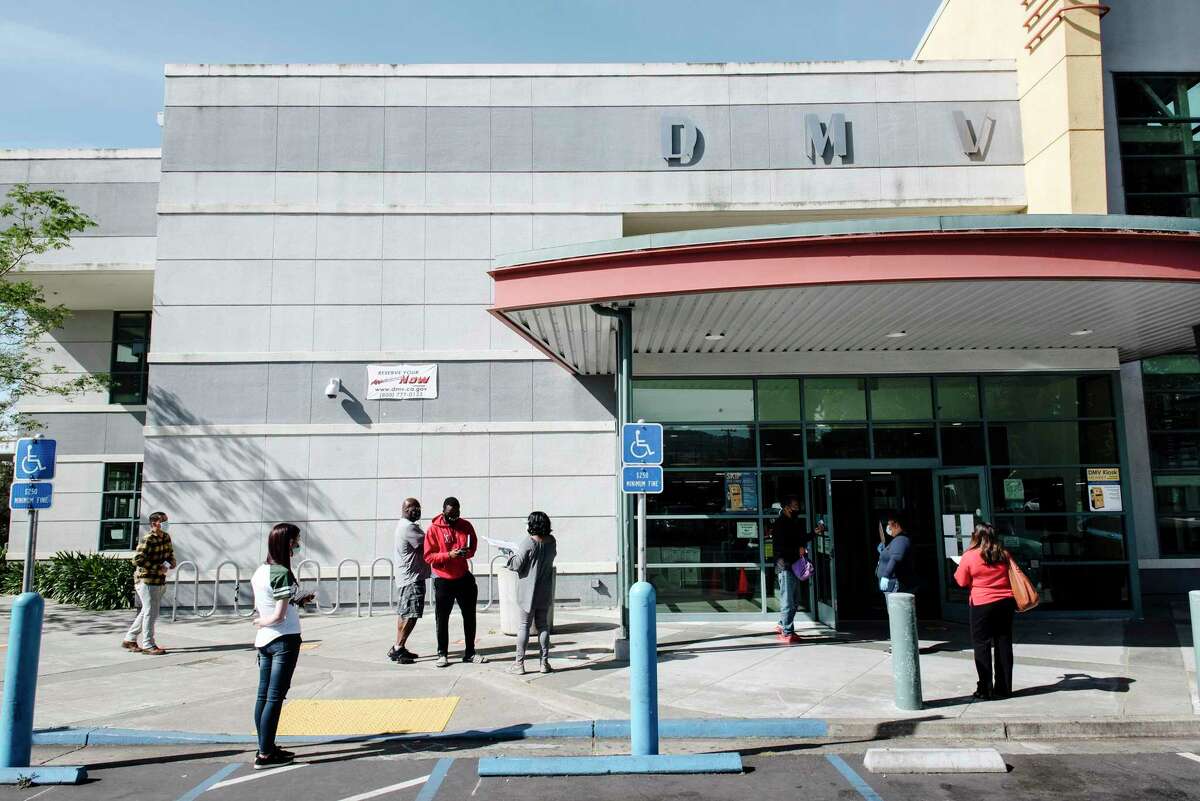 Customers wait outside a Department of Motor Vehicles office in Oakland, Calif, on Friday, May 8, 2020.