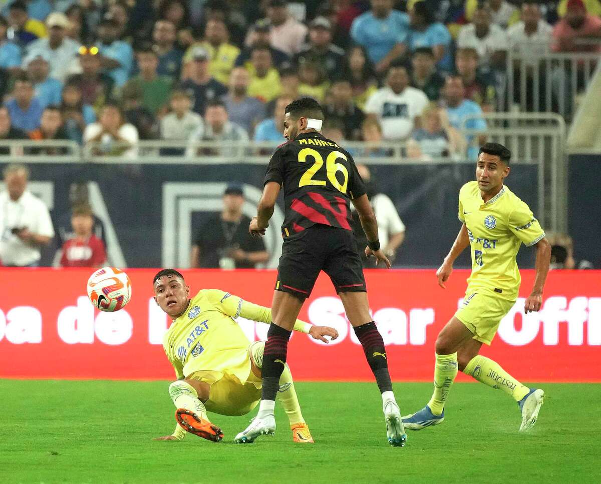 Club América Emilio Lara (23) and Manchester City forward Riyad Mahrez (26) battle for control of the ball during the first half of the Copa de Lone Star soccer match at NRG Stadium on Wednesday, July 20, 2022 in Houston.