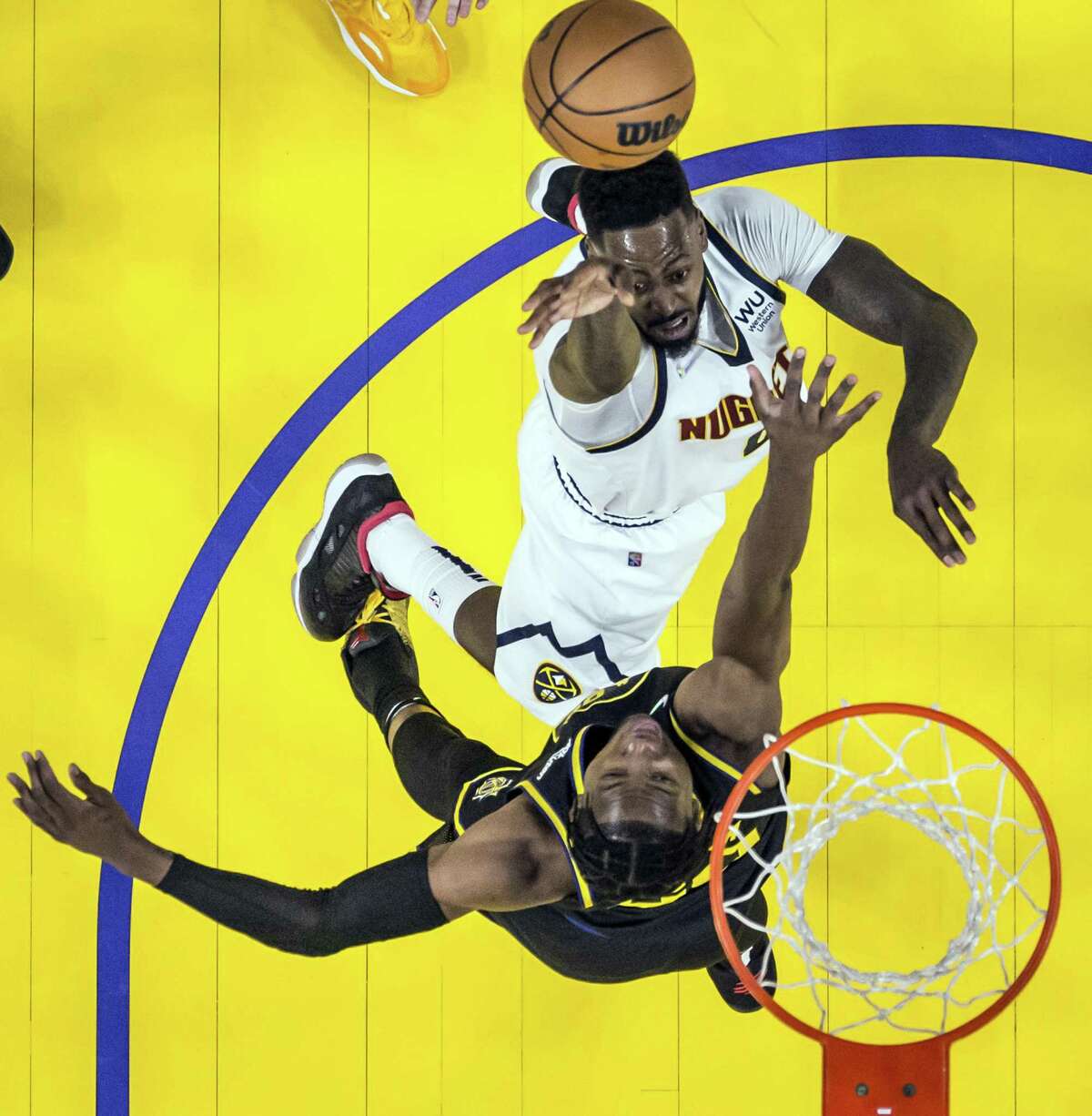 JaMychal Green (0) puts a shot over Jonathan Kuminga (00) as the Golden State Warriors played the Denver Nuggets at Chase Center in San Francisco, Calif., on Wednesday, February 16, 2022. The Warriors were defeated 117-116 on a last second three pointer by Monte Morris (11)