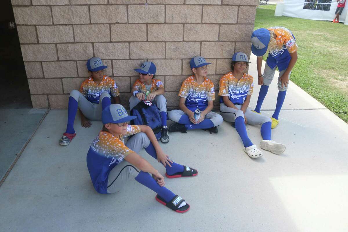 Members of the Buffalo Valley Bronco all-stars fine shade by the Ruth Minchen Athletic Complex concession stand Wednesday.