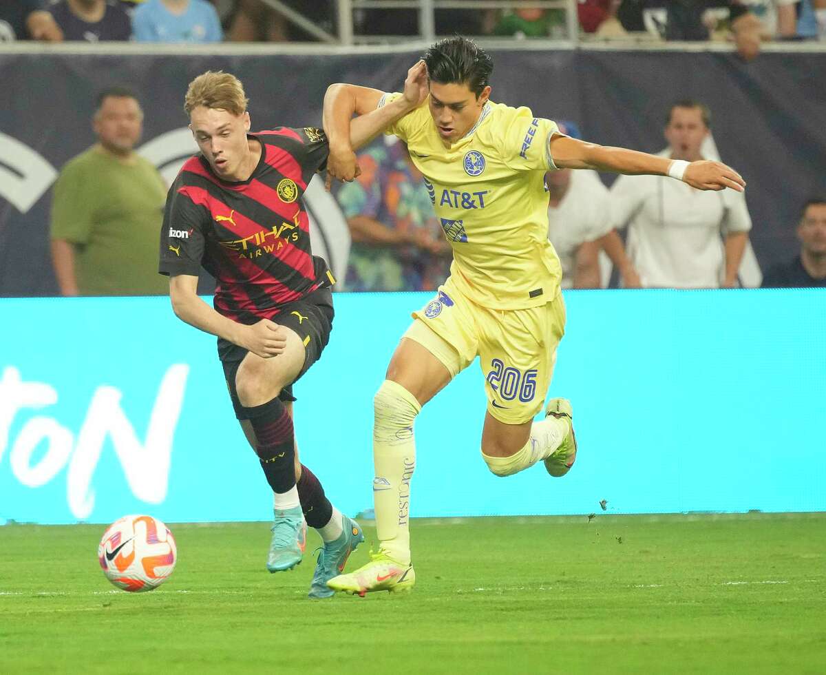 Manchester City midfielder Cole Palmer (80) battles against Club América's Mauricio Reyes (206) during the second half of the Copa de Lone Star soccer match at NRG Stadium on Wednesday, July 20, 2022 in Houston.