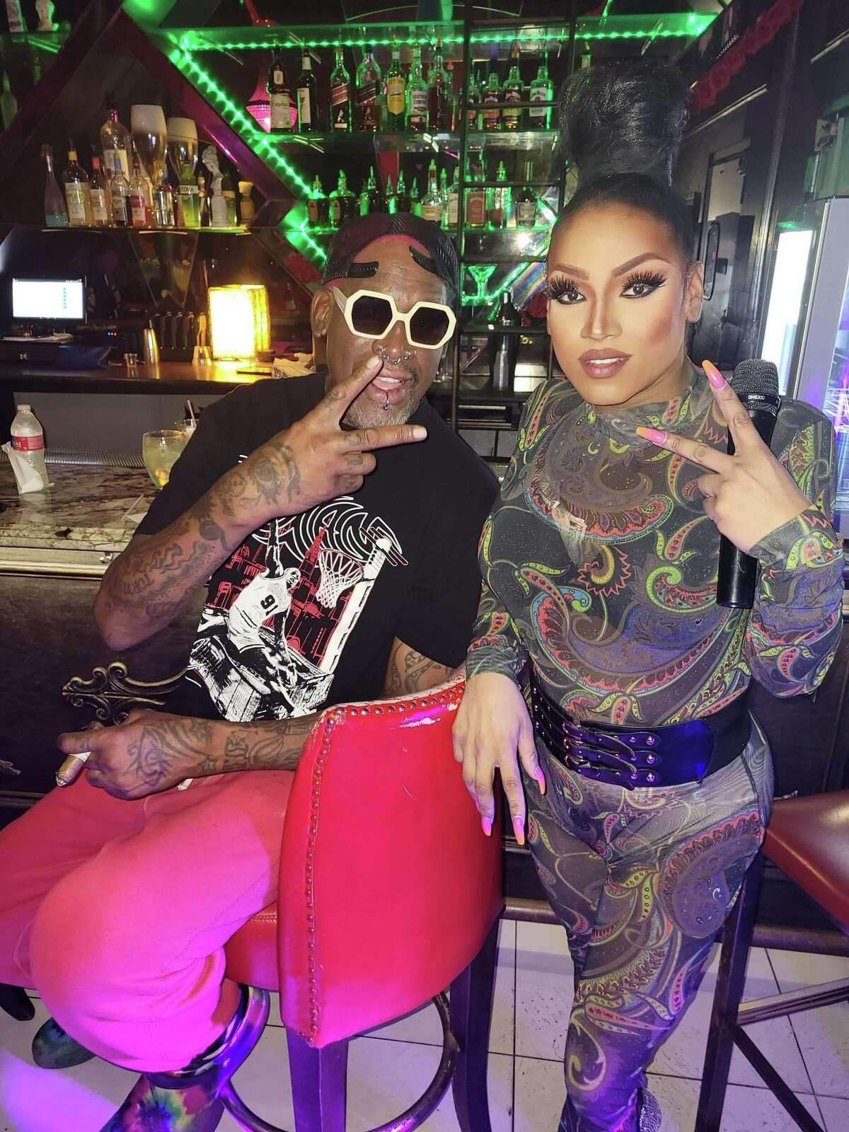 Dennis Rodman with Hamburger Mary's show director Alexye'us Paris in downtown Houston.