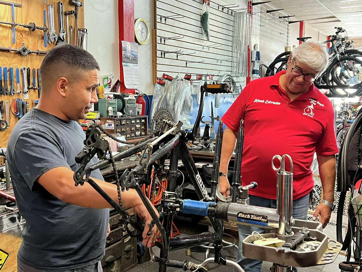 X and Hank Estrada get to work on their bikes.
