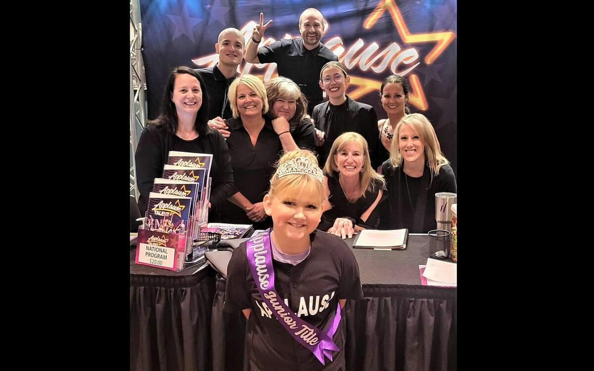 Gracie Boggs, of Manistee, poses for a photo with with Applause Talent staff after winning the First Call Junior Applause Title at a national competition in St. Louis, Missouri.