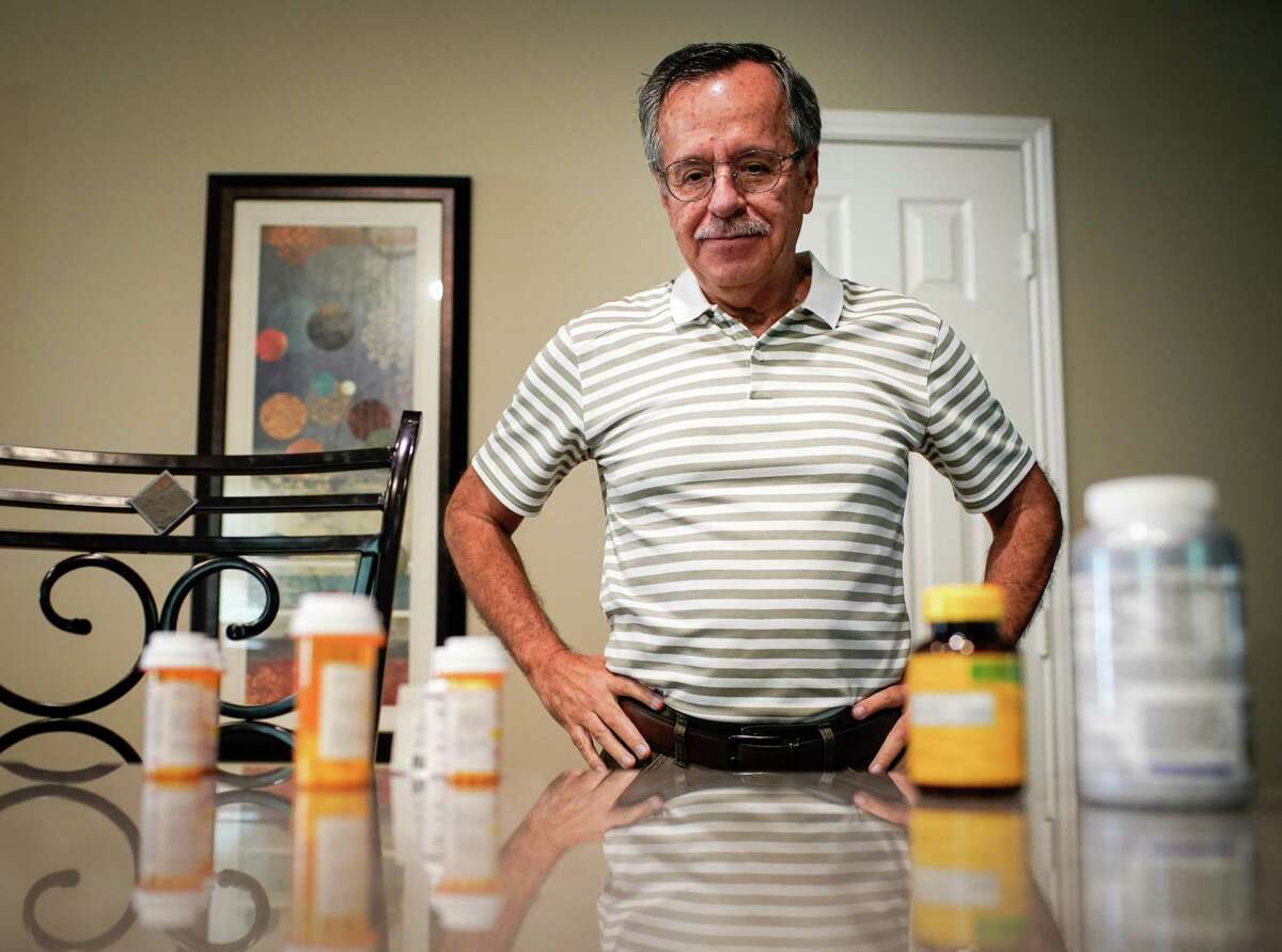 Enrique Barrientos 69, pauses to look at four of his heart medications and two vitamins he takes Thursday, July 21, 2022, at his home in Katy. He suffered a heart attack in early April and takes several medicines as a result. Excessive heat can interact negatively with certain medicines, making people more susceptible to dangerously low blood pressure, dehydration and exhaustion.