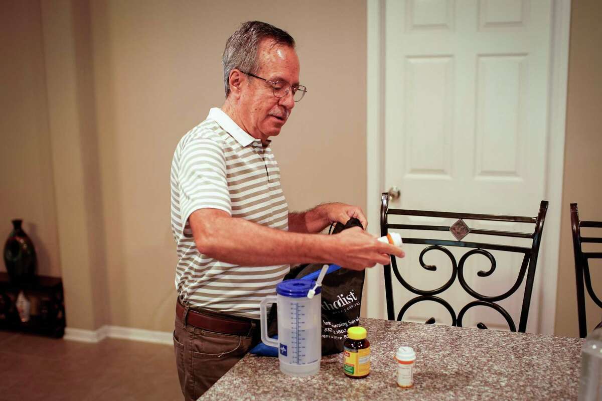 Enrique Barrientos 69, takes out four of his heart medications and two vitamins he takes Thursday, July 21, 2022, at his home in Katy. He suffered a heart attack in early April and takes several medicines as a result. Excessive heat can interact negatively with certain medicines, making people more susceptible to dangerously low blood pressure, dehydration and exhaustion.