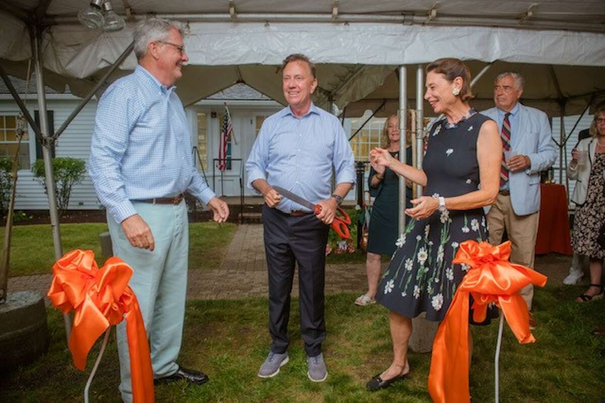 Gov. Ned Lamont celebrates the opening of Globe Pequot's new headquarters with Blythe and Jed Lyons, CEO of Rowman & Littlefield.