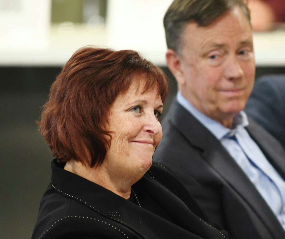 Margaret Keane, executive chairwoman of Synchrony, sits next to Gov. Ned Lamont, during an event at the company’s headquarters at 777 Long Ridge Road in Stamford, Conn., on April 25, 2022. 