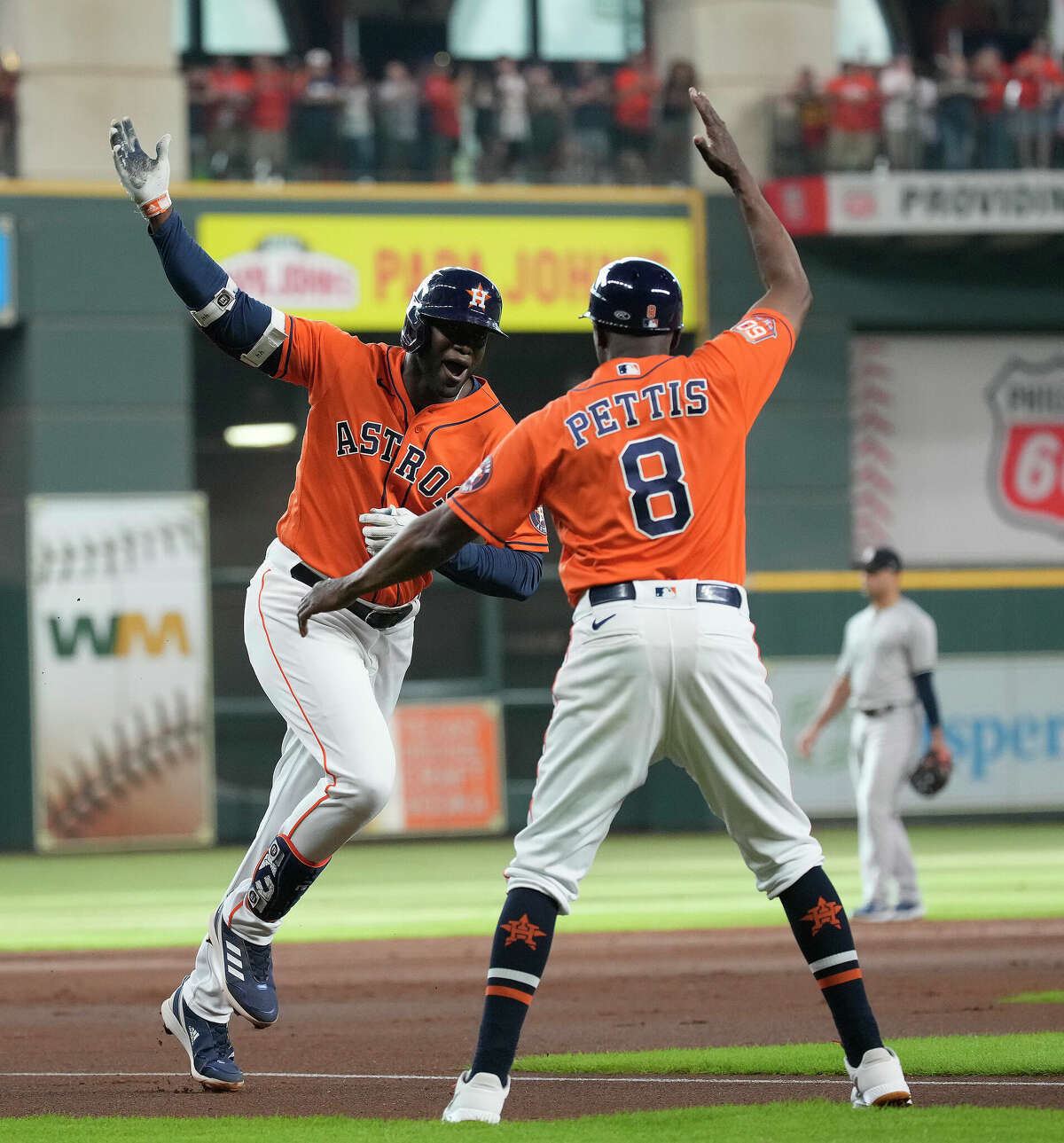 Houston Astros designated hitter Yordan Alvarez (44) celebrates with third base coach Gary Pettis (8) after hitting a home run off of New York Yankees starting pitcher Domingo German during the first inning of Game two of a doublehead MLB baseball game at Minute Maid Park on Thursday, July 21, 2022 in Houston.