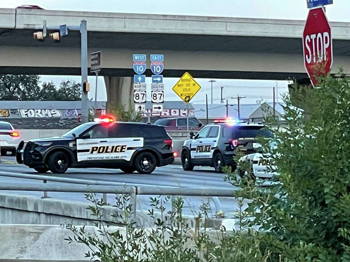 San Antonio police investigate the scene where an officer and a man were injured in a shooting following a brief chase along Culebra Road at Interstate 10 West.