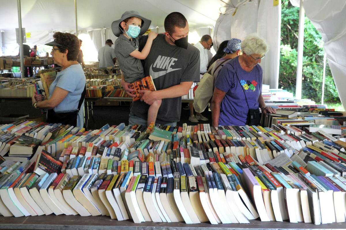 Patrons browse for books under the main tent at the Pequot Library’s summer book sale, in Fairfield on July 23, 2021. The 61st annual event opened Thursday and runs through Tuesday.