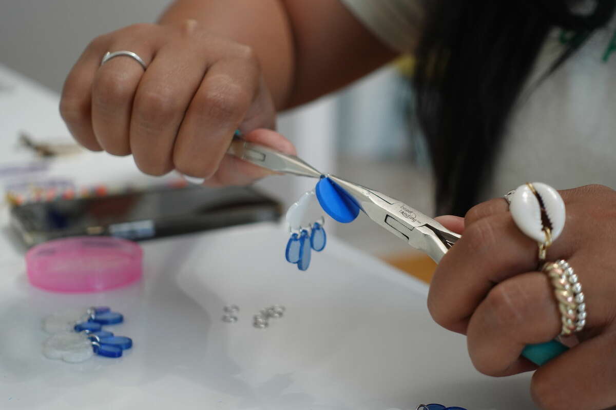 Amanda Enid Davis of ENID&CO. manufacturing "Aguacero" earrings at her Norwalk home on Wednesday, July 6, 2022.