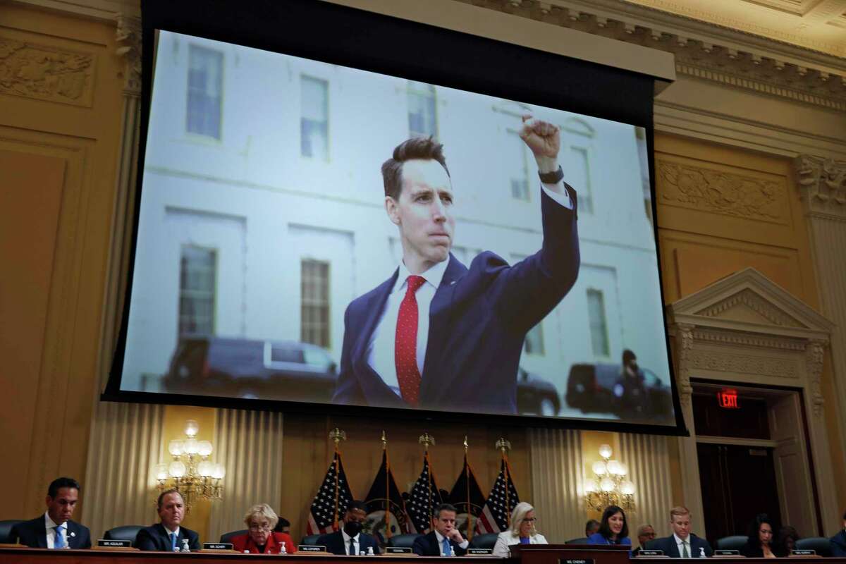 A photograph of Sen. Josh Hawley, R-Mo., pumping his fist toward the rioters on Jan. 6, 2021 is shown during a prime-time hearing of the House Select Committee on July 21, 2022 in Washington, D.C.