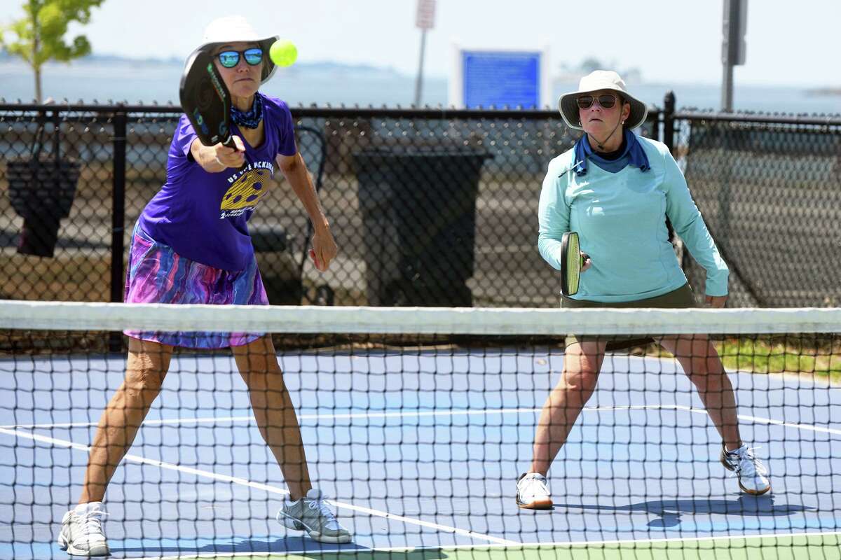 Christine Brewer, left, and Nany Crofts play pickleball at Compo Beach Park in Westport on July 19.