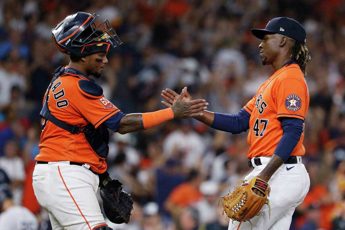 Houston Astros catcher Martin Maldonado and relief pitcher Rafael Montero celebrate the team's 7-5 victory in a baseball game against the New York Yankees on Thursday, July 21, 2022, in Houston. (AP Photo/Kevin M. Cox)