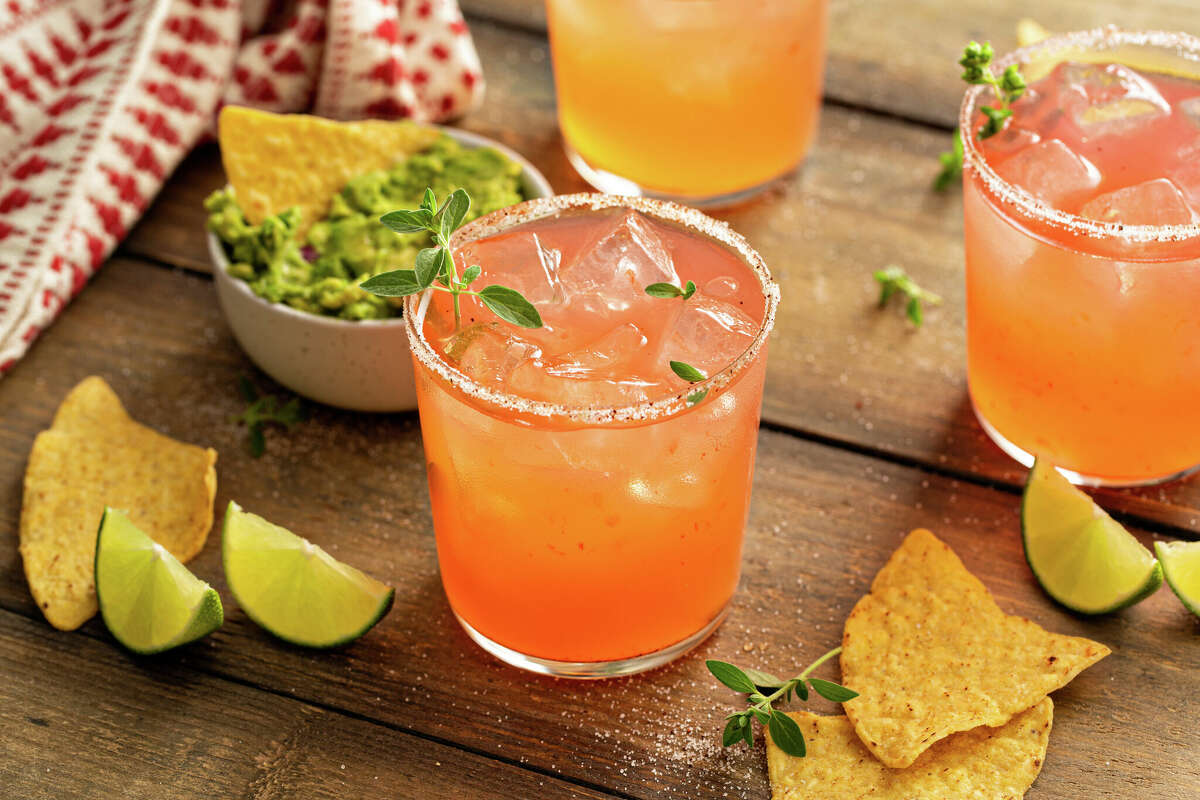 A paloma cocktail is shown, paired with chips and guacamole. The drink is typically made with tequila, lime juice and grapefruit soda but can also be made with sotol, lime juice and grapefruit juice.