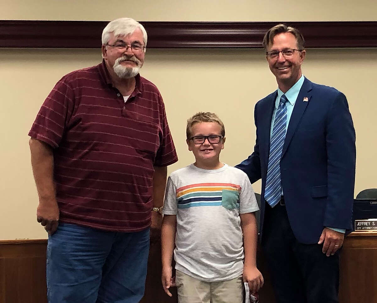 Jameson Unangst, 7, center, poses with his grandfather, Rich Rezabek, left, and Edwardsville Mayor Art Risavy Tuesday. Rezabek is a former city councilman.