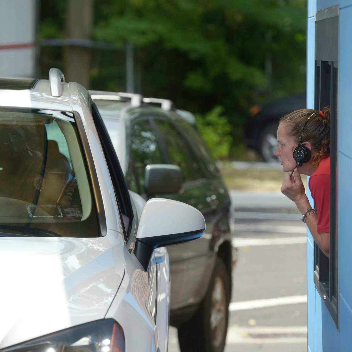 Maureen Allen, assistant manager, leans out the drive-thru window to speak with a customer at the grand opening of a new Sonic restaurant on White Street. Owner Mir Ahmed also owns another Sonic in New Milford. Thursday, July 21, 2022, Danbury, Conn.
