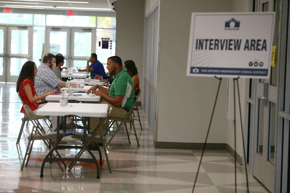 Prospective teachers sit for interviews with school administrators at a job fair at Brackenridge High School on July 14. Almost half of the 121 educators who attended got a job offer.