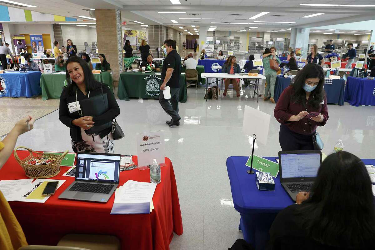 Job applicants Isabel Lomeli (right) and Brenda Ramirez (left) meet with school administrators at a job fair at Brackenridge High School on July 14 in hopes of getting a teaching position. Almost half of the 121 educators who attended got a job offer.