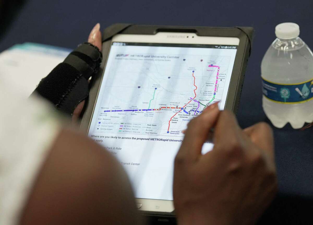A person looks at a map of the proposed Metropolitan Transit Authority's planned University Corridor on a tablet during Metro’s open house on Wednesday, July 20, 2022, at Houston Community College Central Campus in Houston. The planned University Corridor will be among the largest bus rapid transit routes in the nation, connecting numerous neighborhoods and transit centers.