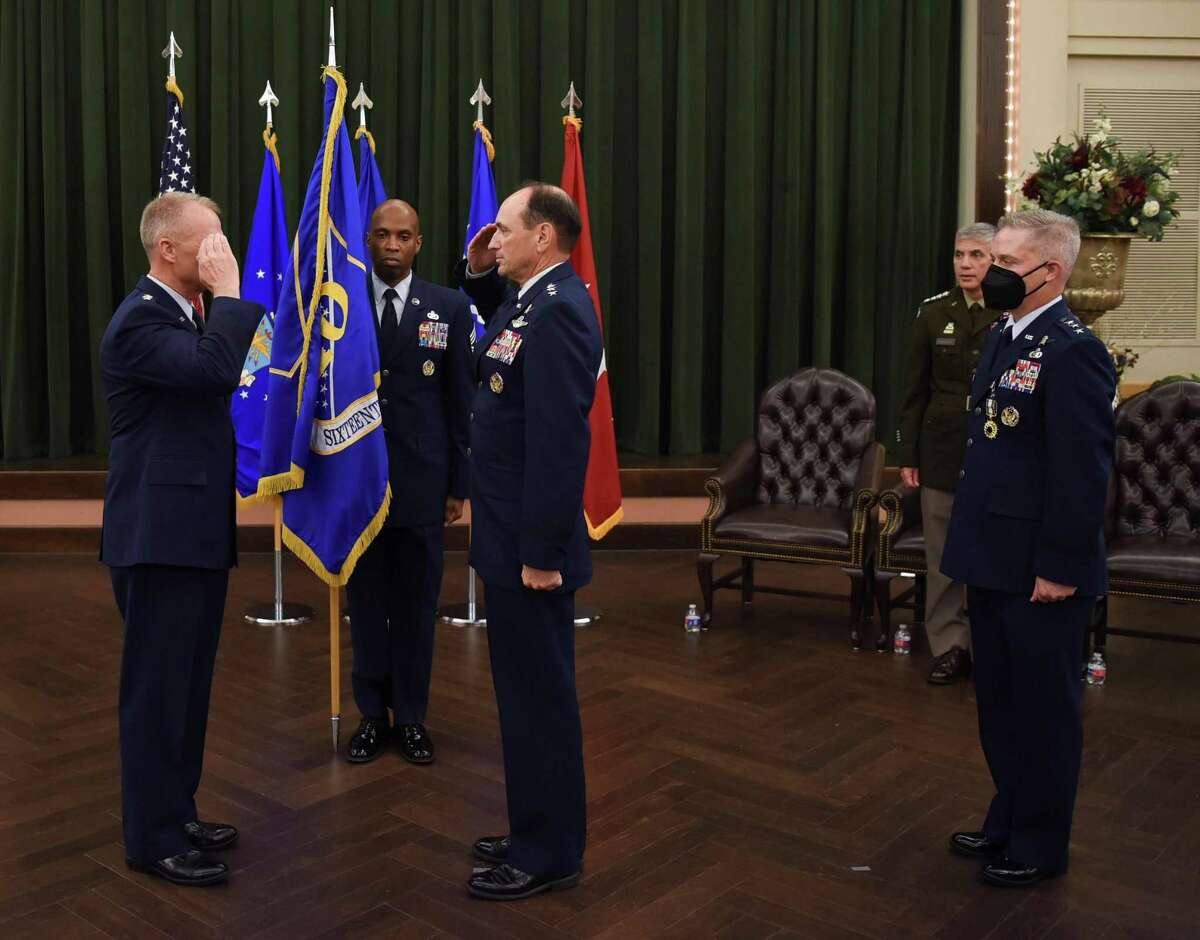 Lt. Gen. Kevin B. Kennedy, center, salutes Gen. Mark D. Kelly after he assumed command of the 16th Air Force, or Air Forces Cyber, from Lt. Gen. Timothy D. Haugh, right, in a ceremony at JBSA-Lackland Thursday