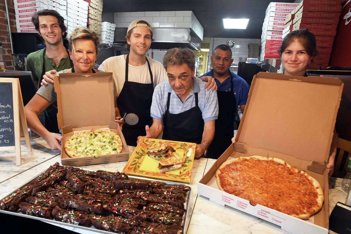 Melissa Emanuel, second from left, poses with from left, sons Sal and Nick, and staff members Florando Darcangelo, Eduardo Agular and Brooke Buckmir at Dal Mare Pizzeria, in the Lordship section of Stratford, Conn. July 20, 2022.