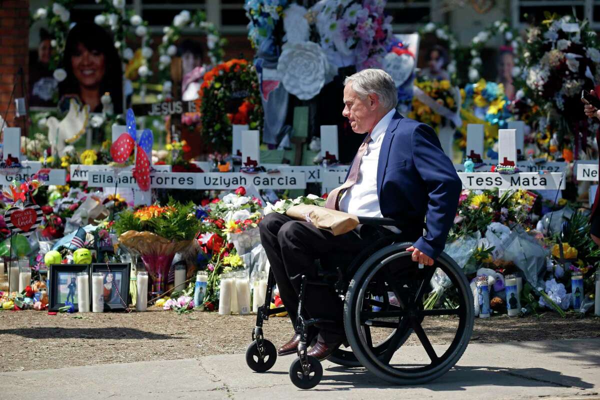 Texas Governor Greg Abbott passes in front of a memorial outside Robb Elementary School to honor the victims killed in this week's school shooting in Uvalde, Texas, Sunday, May 29, 2022. (AP Photo/Dario Lopez-Mills)