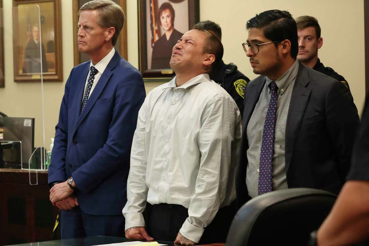 David James Estrada Jr., center, reacts as family impact statements are read in the punishment phase of his murder trial Friday. He was sentenced to 15 years in prison for killing his ex-wife, Dominga Irene Pesqueda, 33, in 2020. With him are his attorneys, Adam Scharff, left, and Adrian Flores.