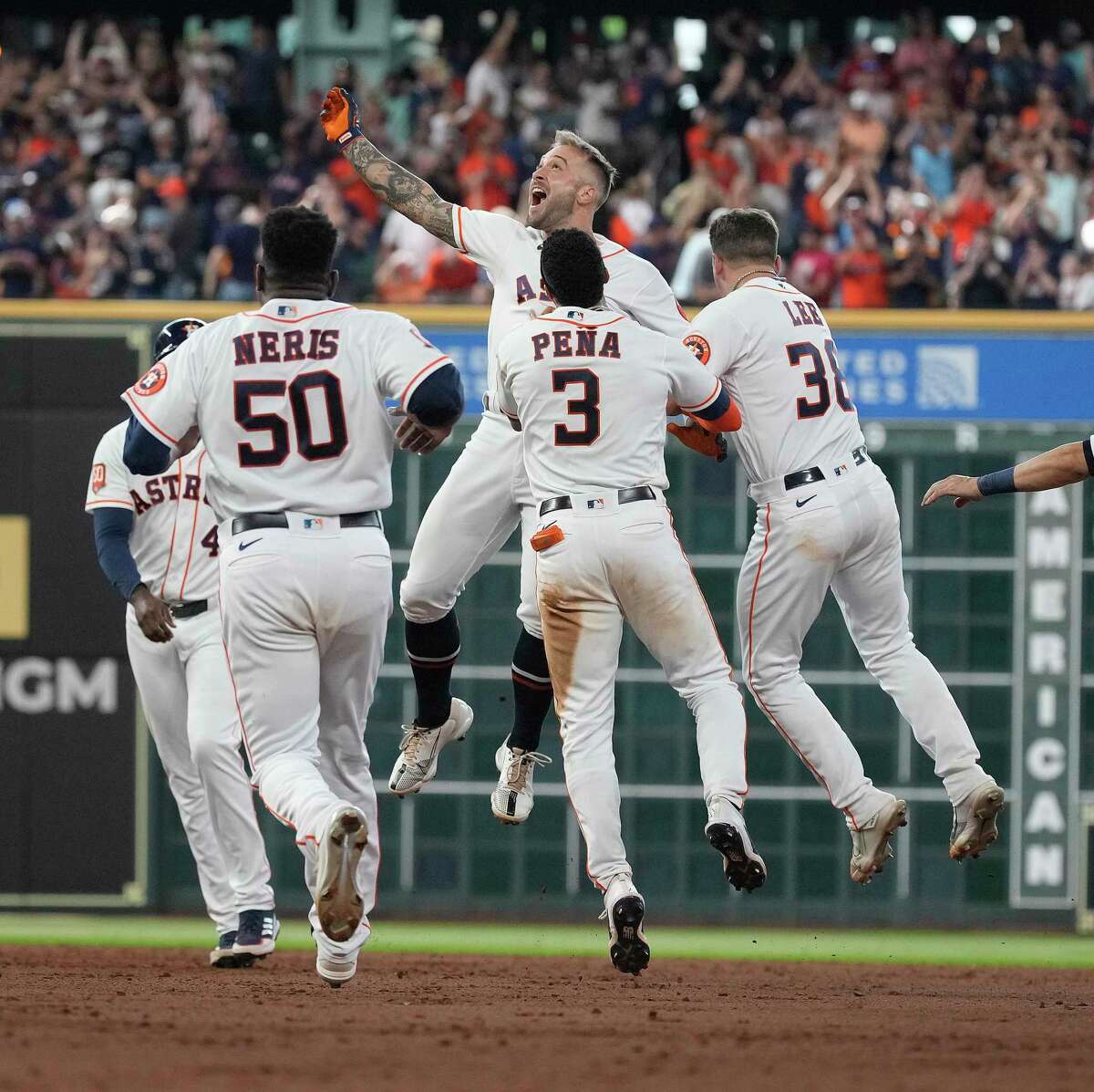 Houston Astros first baseman J.J. Matijevic (13) celebrates as he was surrounded by teammates after his walk off to beat the New York Yankees 3-2 after the ninth inning of Game one of a double head MLB baseball game at Minute Maid Park on Thursday, July 21, 2022 in Houston.