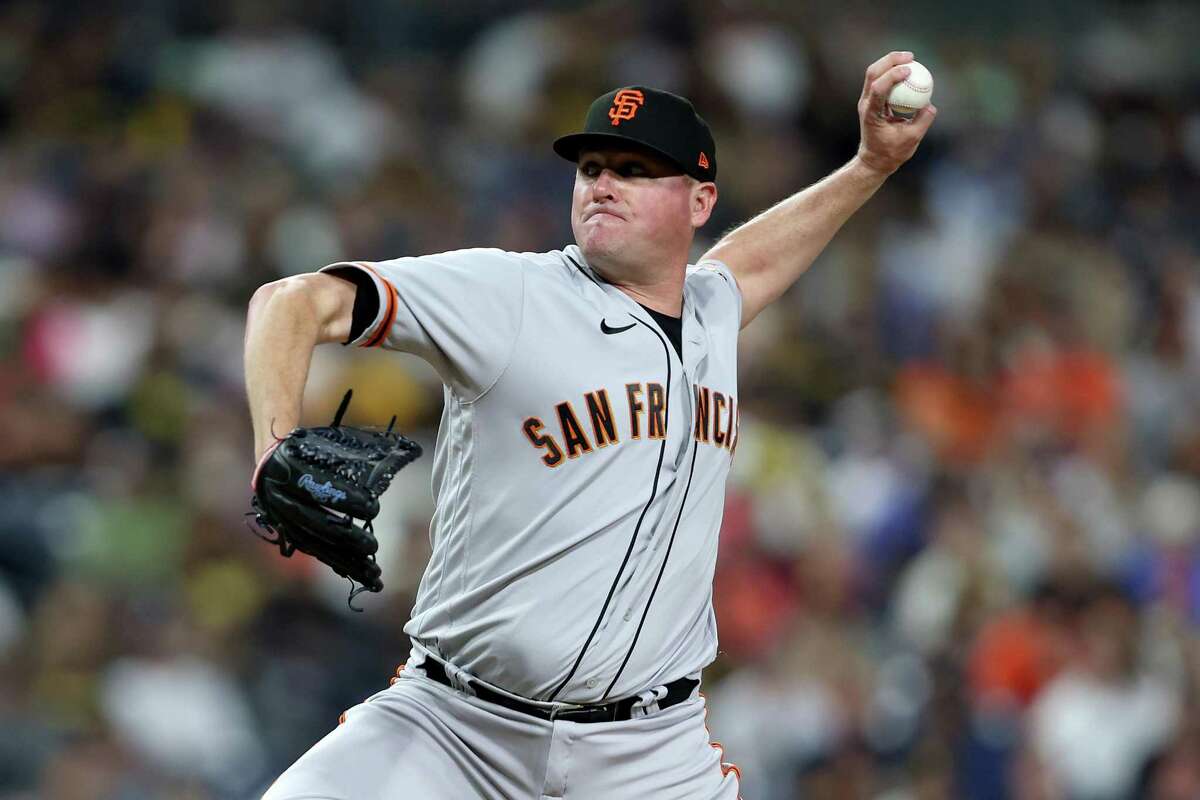 SAN DIEGO, CALIFORNIA - JULY 08: Jake McGee #17 of the San Francisco Giants pitches during the eighth inning of a game against the San Diego Padres at PETCO Park on July 08, 2022 in San Diego, California. (Photo by Sean M. Haffey/Getty Images)