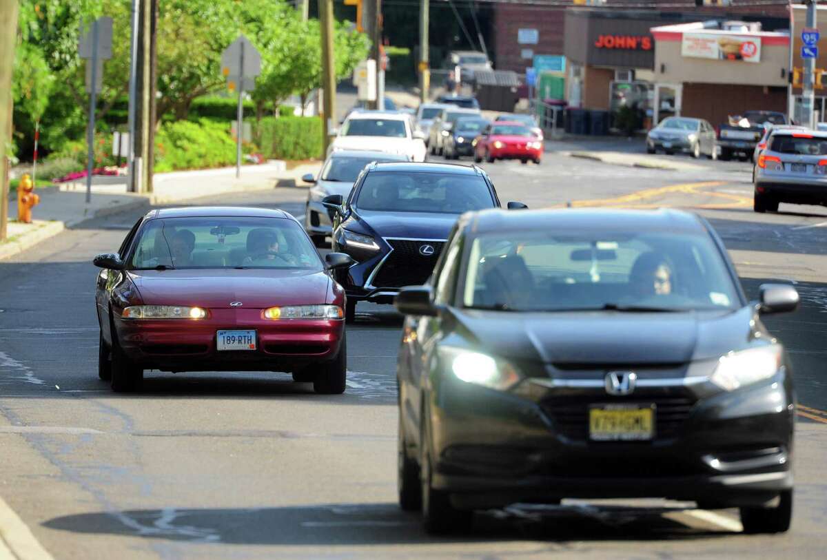 Cars pass by in the front of Stamford High School along Strawberry Hill Ave in Stamford, Conn., on Wednesday July 13, 2022. Among Stamford schools, Stamford High School has the highest rate of traffic accidents and traffic stops over the last three years. In 2016, 18-year-old Karina Tinajero-Arreguin was killed when she was hit by a van while crossing Strawberry Hill Avenue to get to the school.