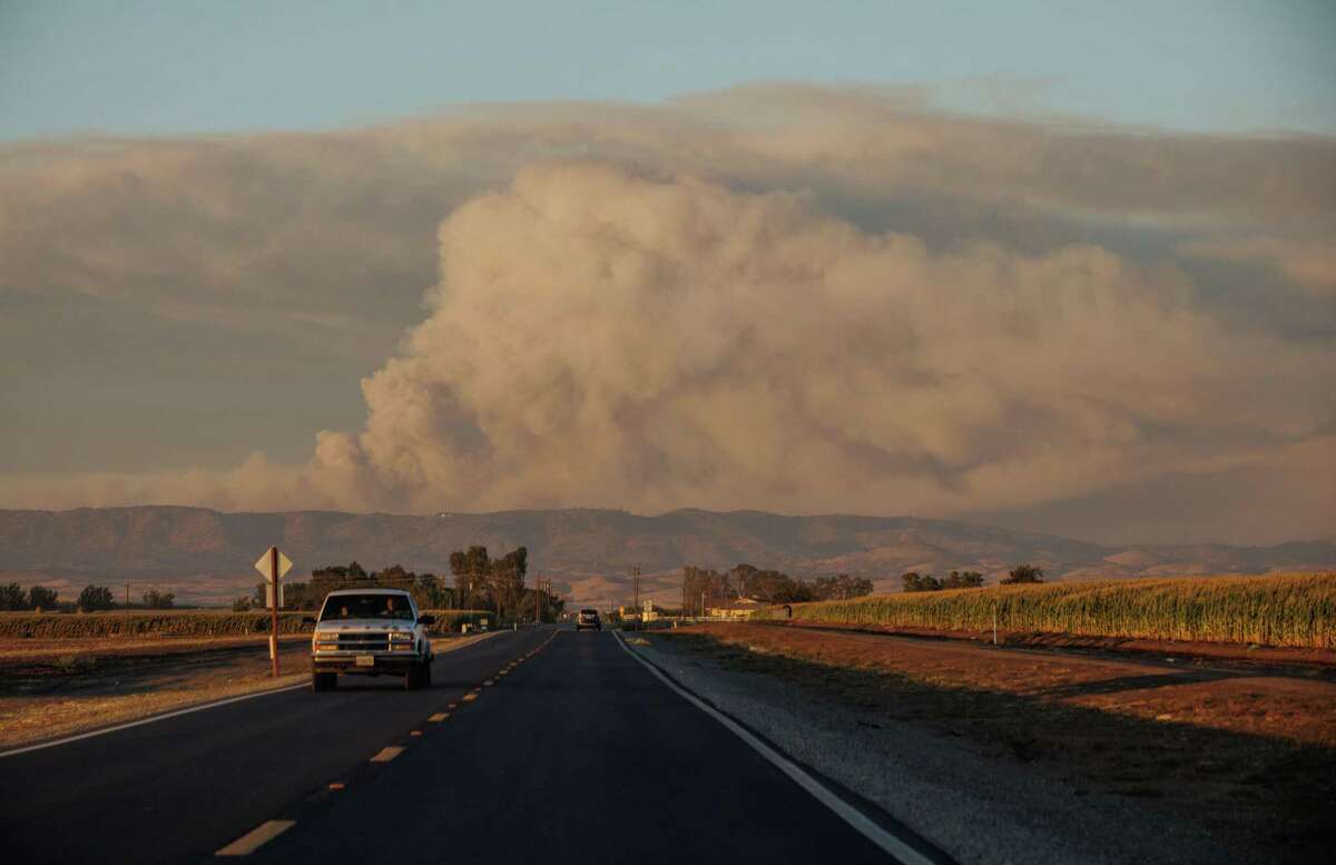A pyrocumulus cloud caused by the Oak Fire is seen from Highway 140 as the blaze burns in Mariposa County.