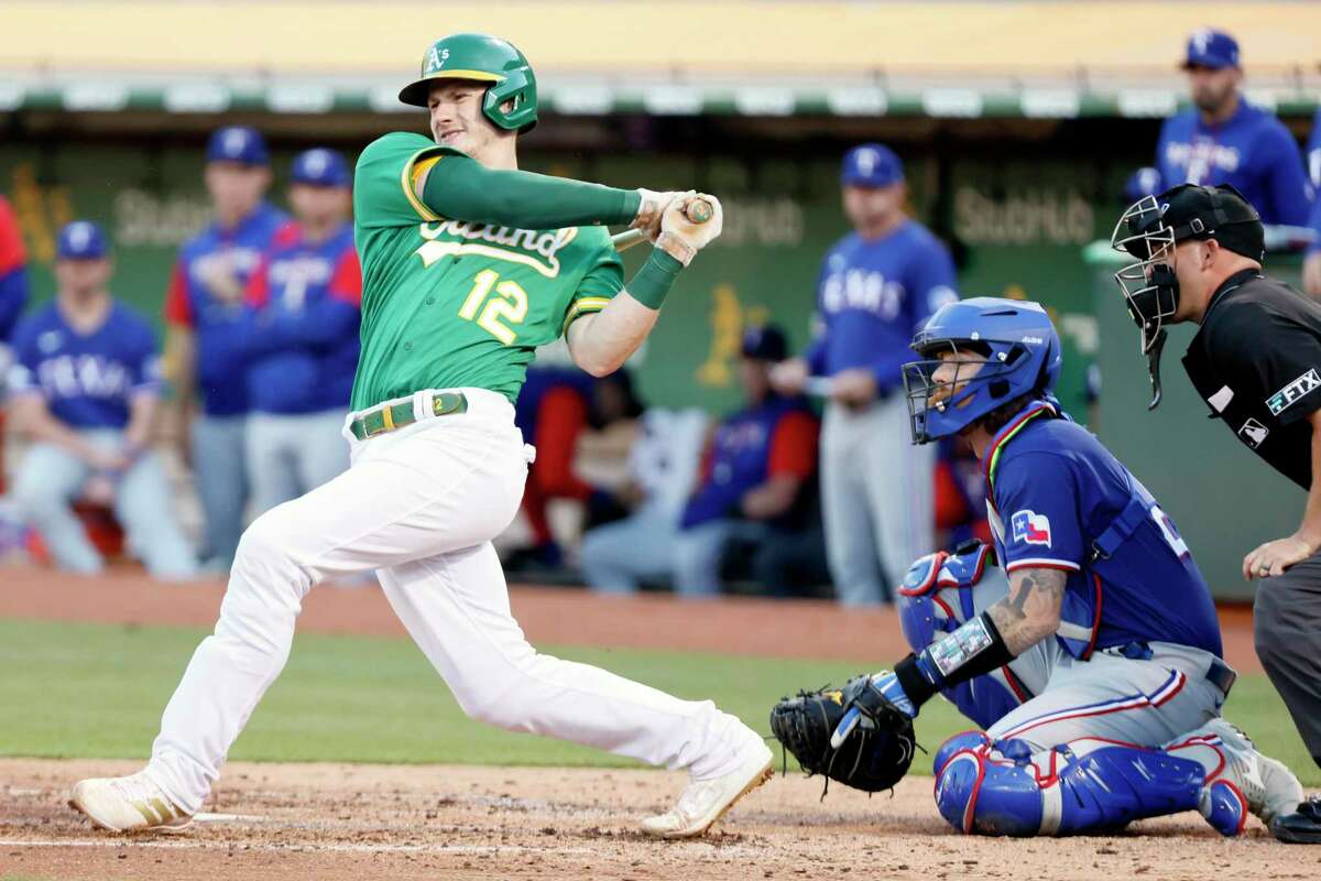 Oakland Athletics catcher Sean Murphy (12) hits a grounder for an out in the 3rd inning during an MLB game against the Texas Rangers at RingCentral Coliseum, Friday, July 22, 2022, in Oakland, Calif.