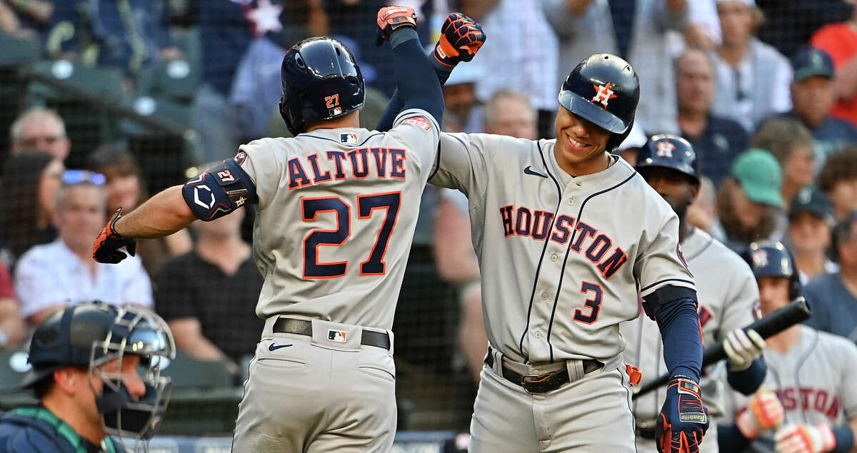 Jose Altuve #27 of the Houston Astros celebrates with Jeremy Pena #3 after hitting a solo home run during the first inning against the Seattle Mariners at T-Mobile Park on July 22, 2022 in Seattle, Washington. (Photo by Alika Jenner/Getty Images)