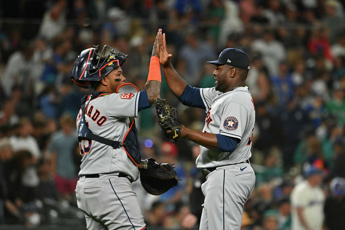 SEATTLE, WASHINGTON - JULY 22: Martin Maldonado #15 of the Houston Astros and Hector Neris #50 high-fives after the game against the Seattle Mariners at T-Mobile Park on July 22, 2022 in Seattle, Washington. The Houston Astros won 5-2. (Photo by Alika Jenner/Getty Images)