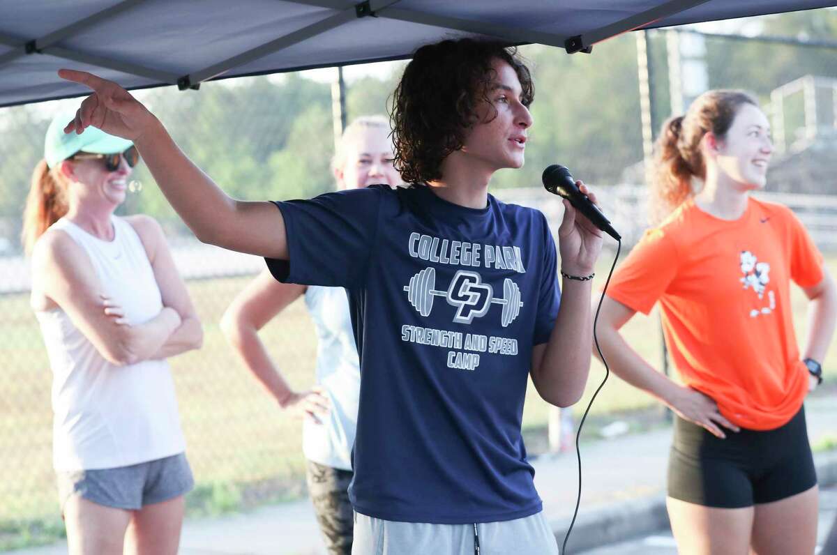 Jacob Snider thanks participants for coming to the Walk for Uvalde at College Park High School, Saturday, July 23, 2022, in The Woodlands. Money raised from the event went to the Robb School Memorial Fund, which will distribute the money in partnership with the National Compassion Fund directly to the families of victims who need assistance.