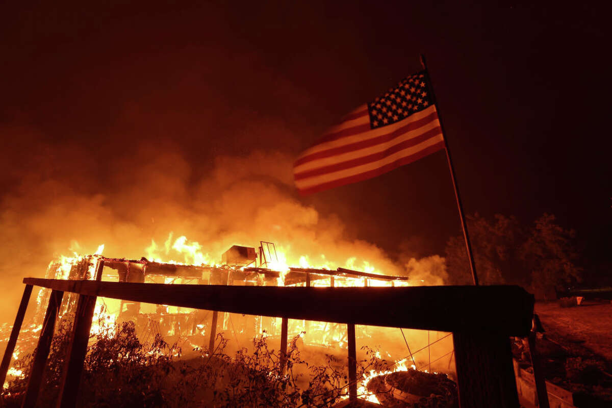 BUT home burns like an oak fire moves through area on July 23, 2022 near Mariposa, California. 