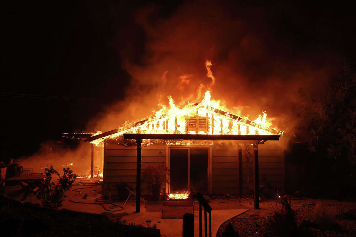 BUT home burns like an oak fire moves through area on July 23, 2022 near Mariposa, California. 