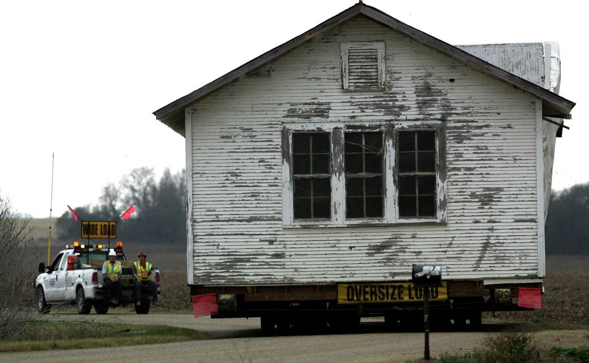 The old Lower Valley schoolhouse moves down the road toward its new location at Loop 1604 and Kitty Hawk Road in February 2008. The schoolhouse served the community for 89 years.