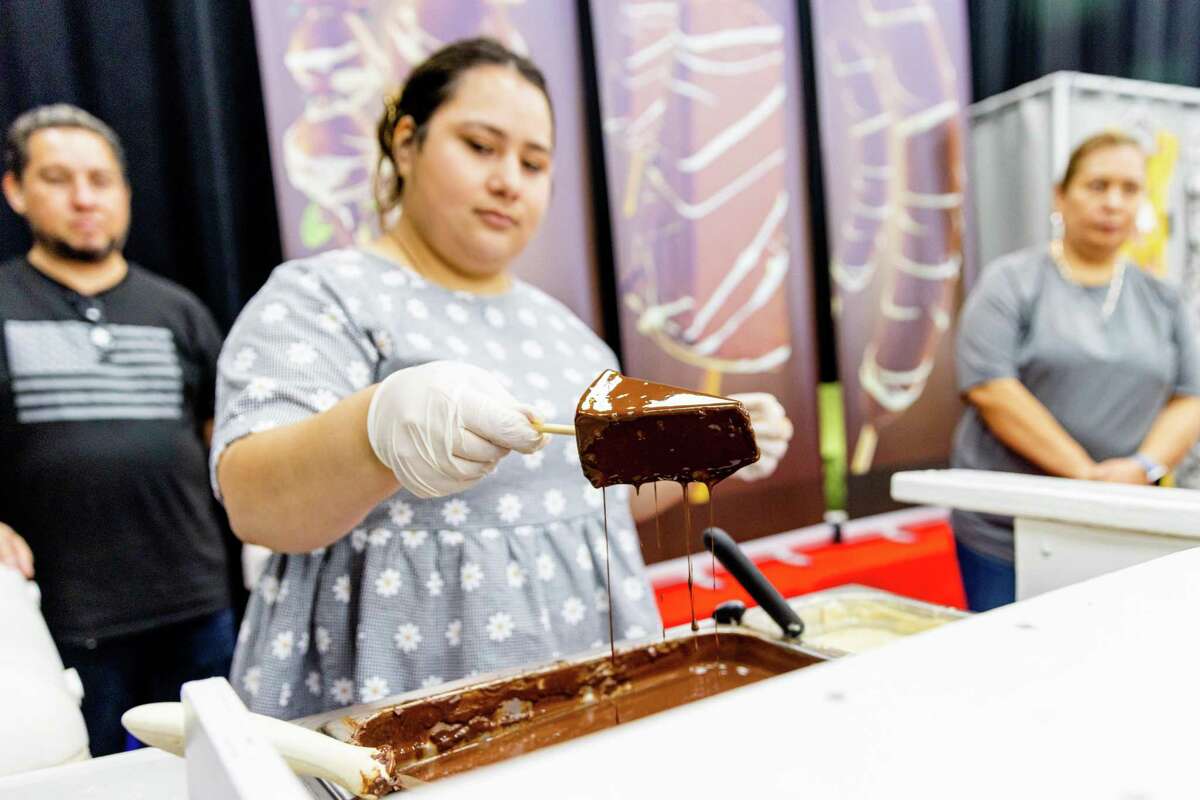 A vendor from Four Reasons dips chocolate cheesecake during the Small Business Expo at the Pasadena Convention Center, Saturday, July 23, 2022, in Pasadena.